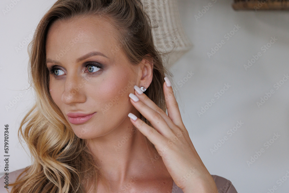 Portrait of beautiful blond woman. Young blond lady in spacious room. Portrait of beautiful blond woman. Young blond lady in spacious room.