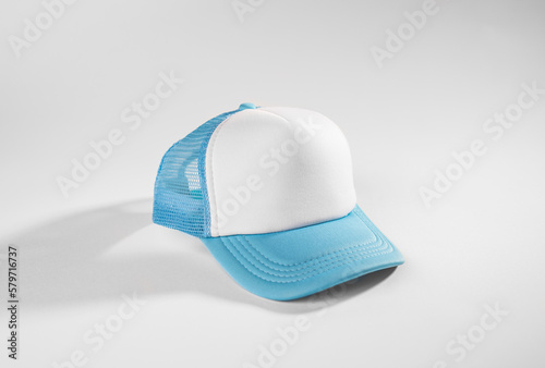 Trucker cap, snapback, light blue with white front, light blue mesh. Isolated on white. Mock-up for branding