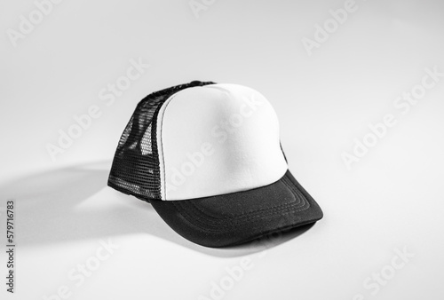 Trucker cap, snapback, black with white front, black, mesh. Isolated on white. Mock-up for branding