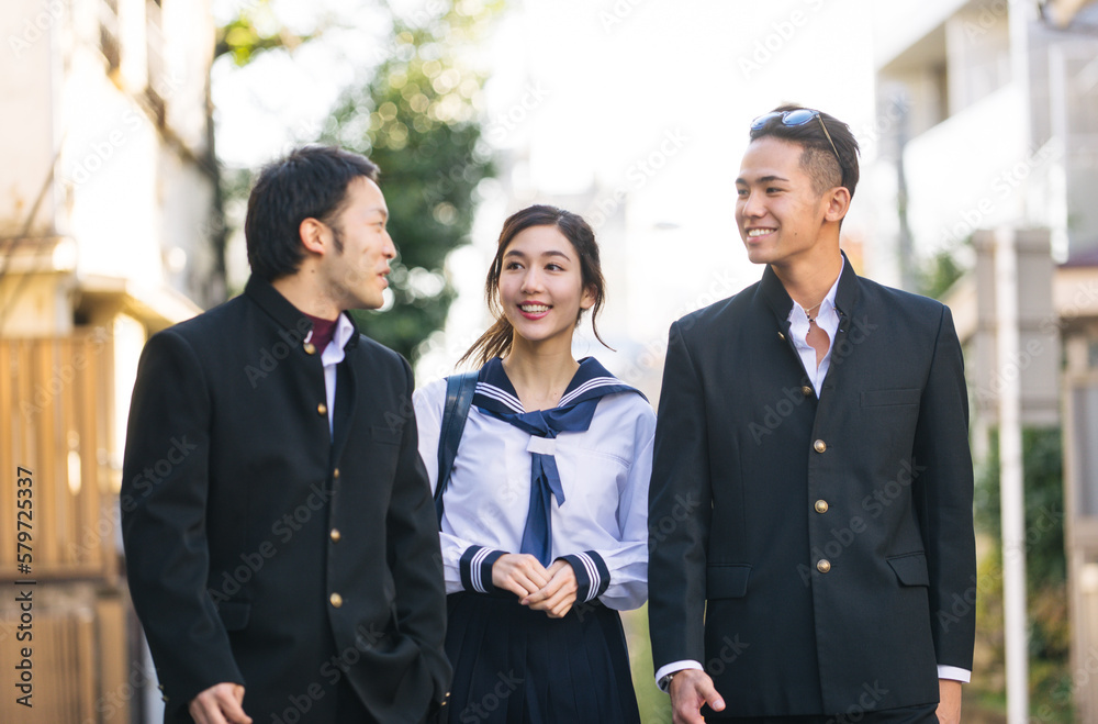 Young japanese students with traditional school college uniforms meeting outdoors in Tokyo - Happy asian friends bonding in the city after school Young japanese students with traditional school college uniforms meeting outdoors in Tokyo - Happy asian friends bonding in the city after school
