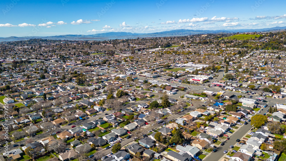 Aerial photos over a community in Vallejo, California with houses, streets, cars and parks on a sunny day in March. - obrazy, fototapety, plakaty 