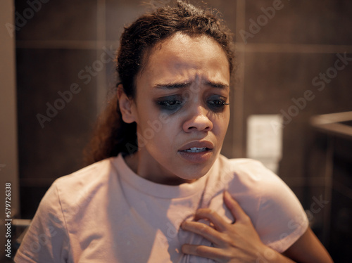 Feel me inside your heart as its bleeding. Shot of a young female experiencing internal turmoil in the bathroom at home.