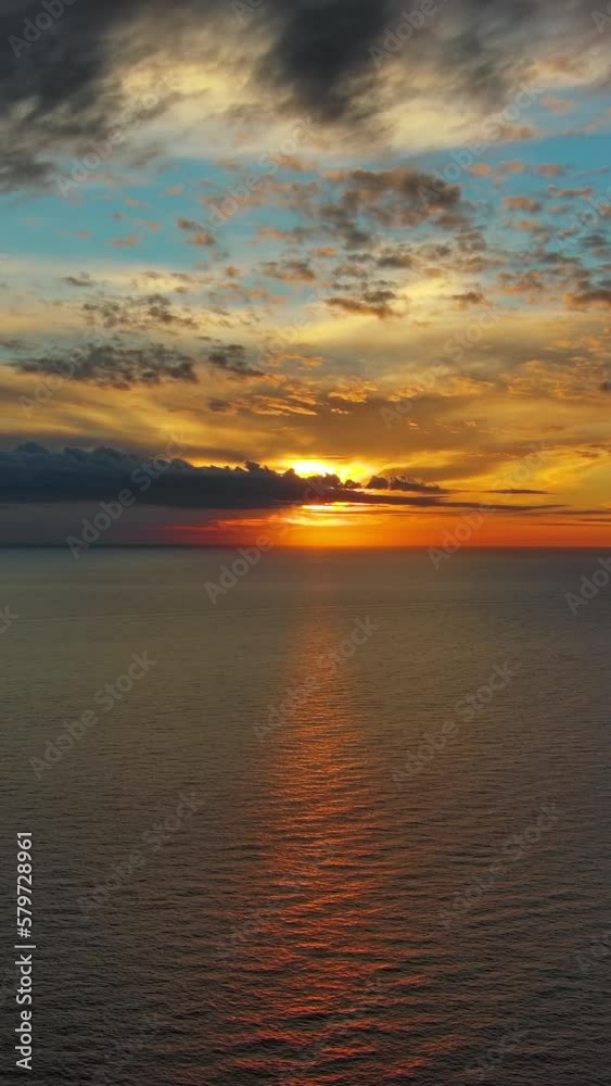 Aerial view of sea surface during a beautiful colourful sunset. Vertical video Aerial view of sea surface during a beautiful colourful sunset. Vertical video