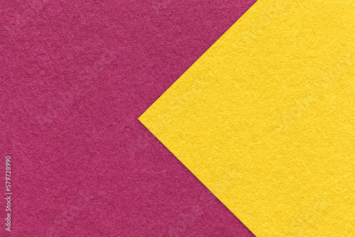 Texture of purple paper background, half two colors with yellow arrow, macro. Structure of dense craft wine cardboard.