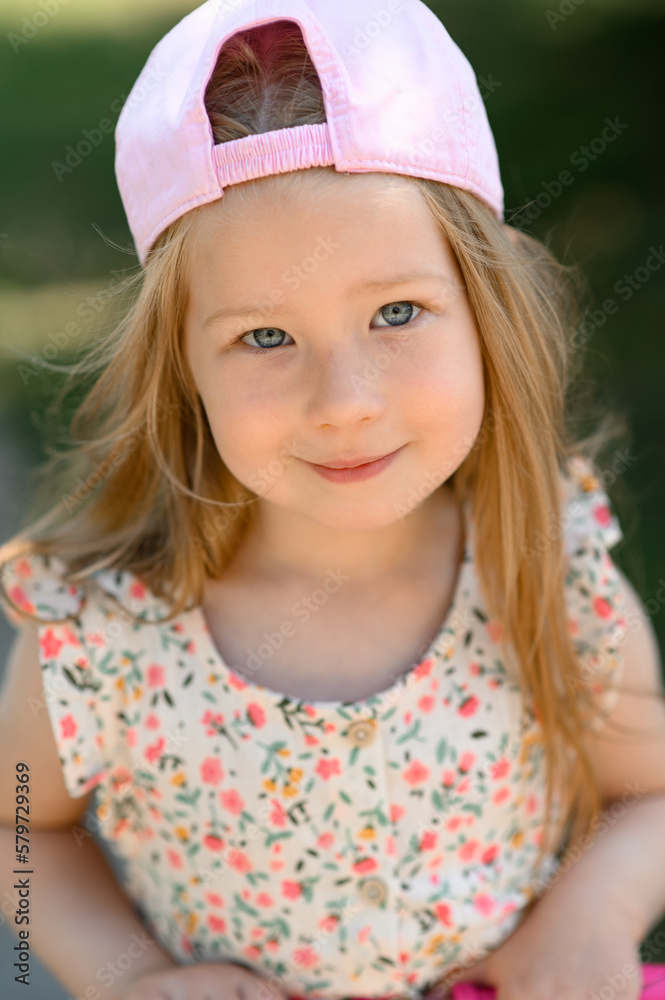 Little girl 3 years old in a pink cap. Close-up. Summer time. Little girl 3 years old in a pink cap. Close-up. Summer time.