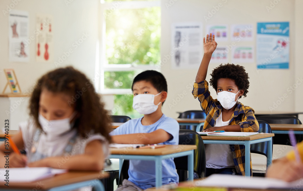 Fototapeta premium Covid, students and education children in school classroom raising hand to answer, ask or question lesson with classmates. Diverse group of kids, boys or girls with face masks learning in study class