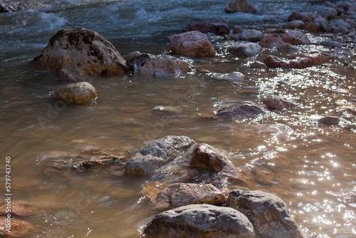 big stones in a mountain river in early spring