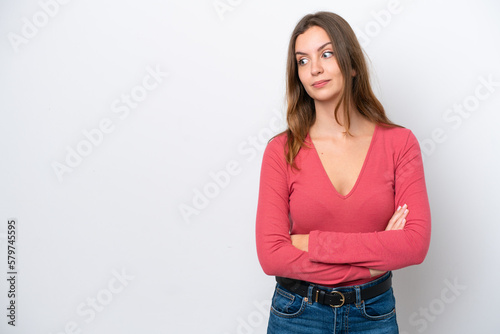 Young caucasian woman isolated on white background making doubts gesture looking side © luismolinero