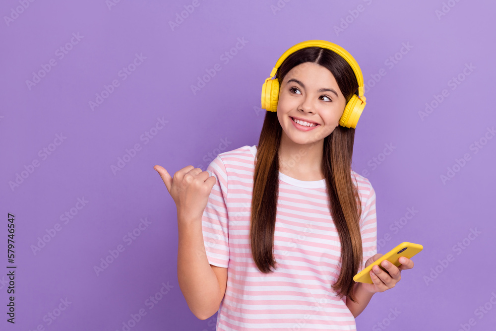 Photo of shiny dreamy girl dressed striped t-shirt enjoying songs modern gadget thumb empty space isolated purple color background Photo of shiny dreamy girl dressed striped t-shirt enjoying songs modern gadget thumb empty space isolated purple color background