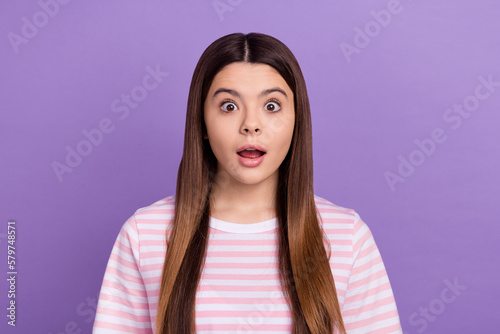 Photo of impressed funny young girl dressed striped white pink t-shirt open mouth isolated purple color background