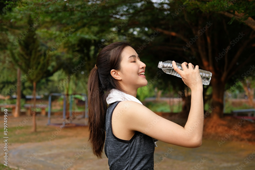 Woman drinking water after workout