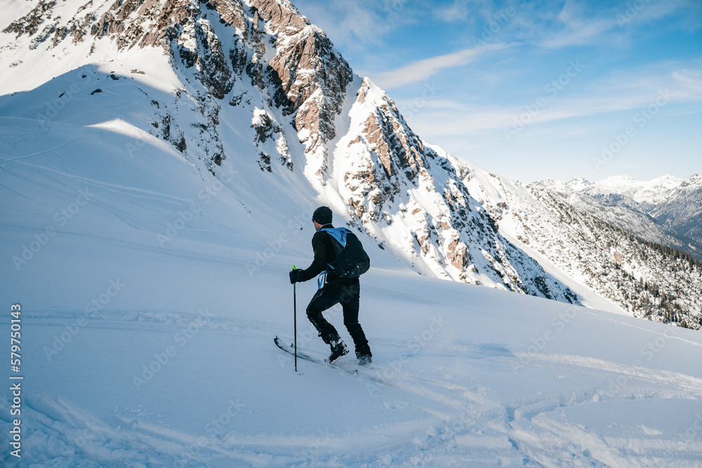Skitouring with amazing view of famous mountains in beautiful winter powder snow of Alps