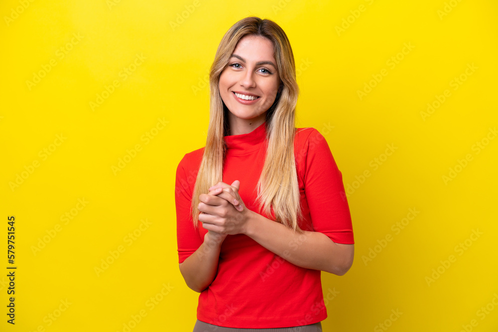 Young Uruguayan woman isolated on yellow background laughing Young Uruguayan woman isolated on yellow background laughing