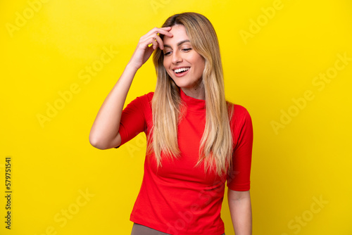 Young Uruguayan woman isolated on yellow background laughing