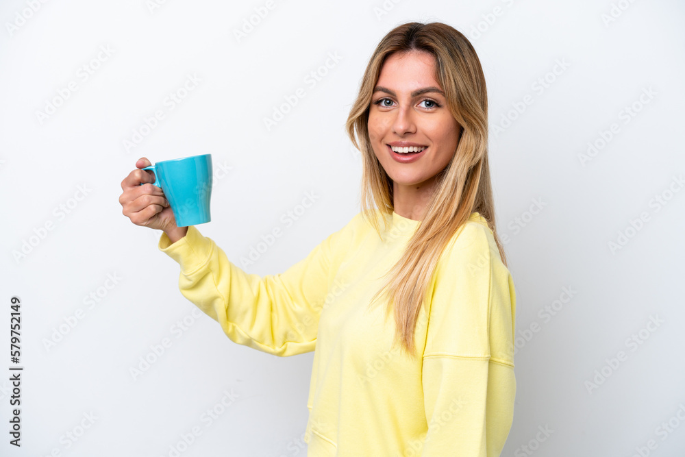 Young Uruguayan woman holding cup of coffee isolated on white background smiling a lot