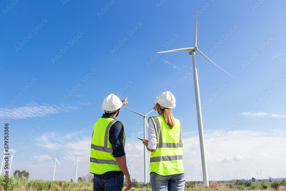 engineer team working in wind turbine farm. Renewable energy with wind generator by alternative energy concept. engineer team working in wind turbine farm. Renewable energy with wind generator by alternative energy concept.