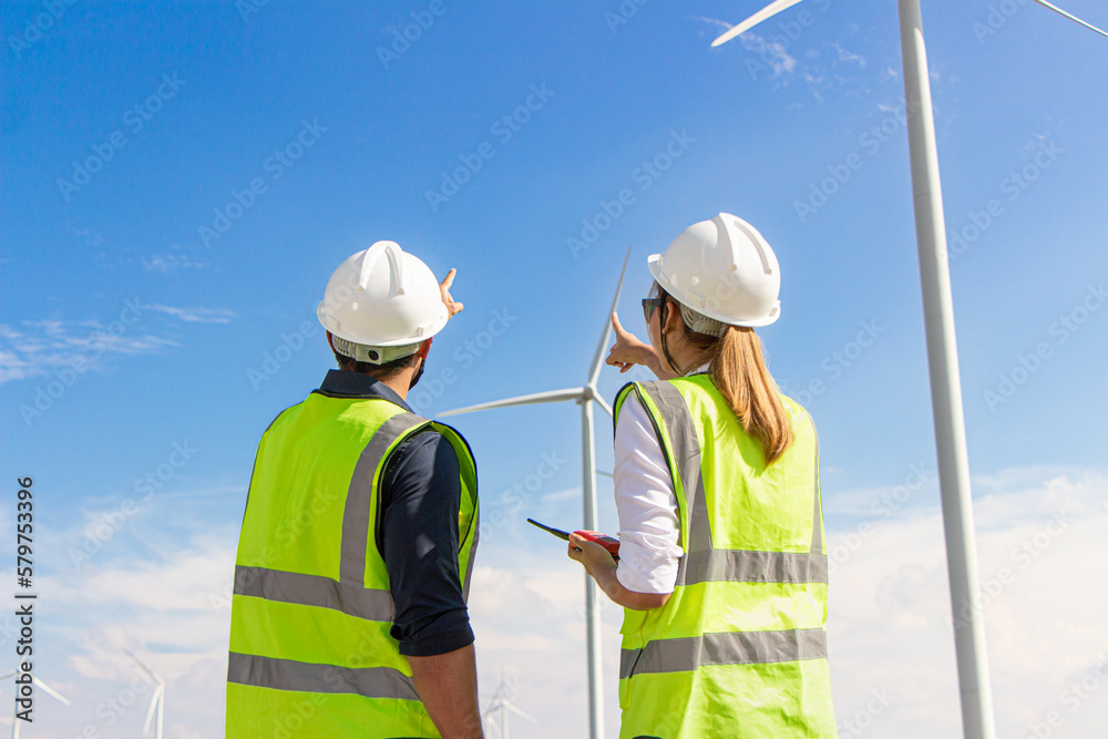 engineer team working in wind turbine farm. Renewable energy with wind generator by alternative energy concept. engineer team working in wind turbine farm. Renewable energy with wind generator by alternative energy concept.