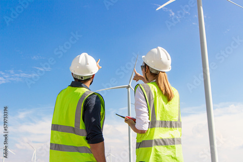 engineer team working in wind turbine farm. Renewable energy with wind generator by alternative energy concept.