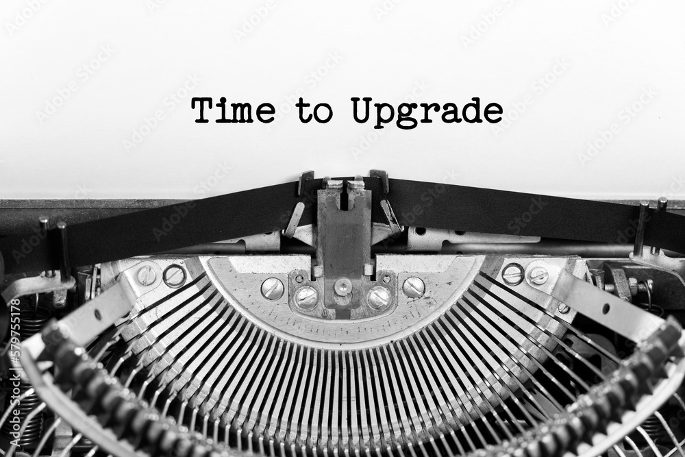 Time to Upgrade phrase closeup being typing and centered on a sheet of paper on old vintage typewriter mechanical - obrazy, fototapety, plakaty 