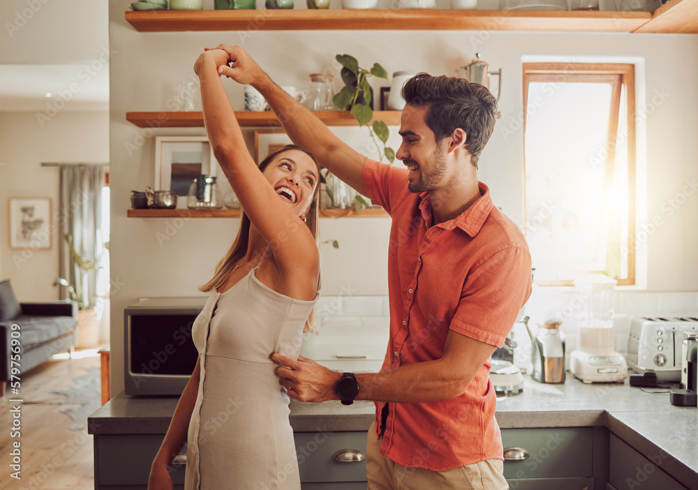 Joyful, dancing and loving couple bonding and having fun in the kitchen together at home. Energetic, fun and active relationship sharing a dance and romantic moment while enjoying their anniversary. - obrazy, fototapety, plakaty 