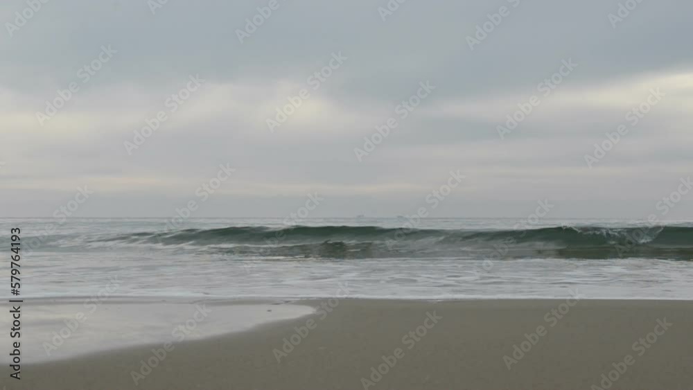 Sea waves on the beach, cloudy weather Sea waves on the beach, cloudy weather