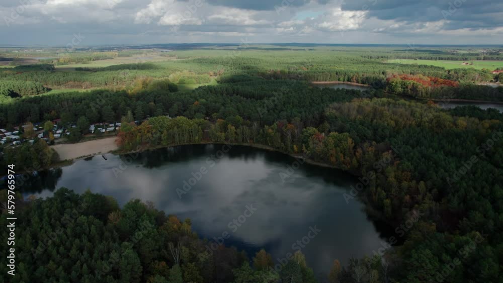 Aerial shot of beautiful lake surrounded by forest in a calm autumn day. Germany. 4K video. Aerial shot of beautiful lake surrounded by forest in a calm autumn day. Germany. 4K video.