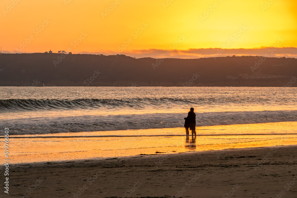 Couple enjoying the sunset on Coronado beach, San Diego, California