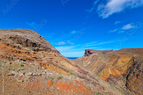 Bright rocks of mountains on an island in the ocean.