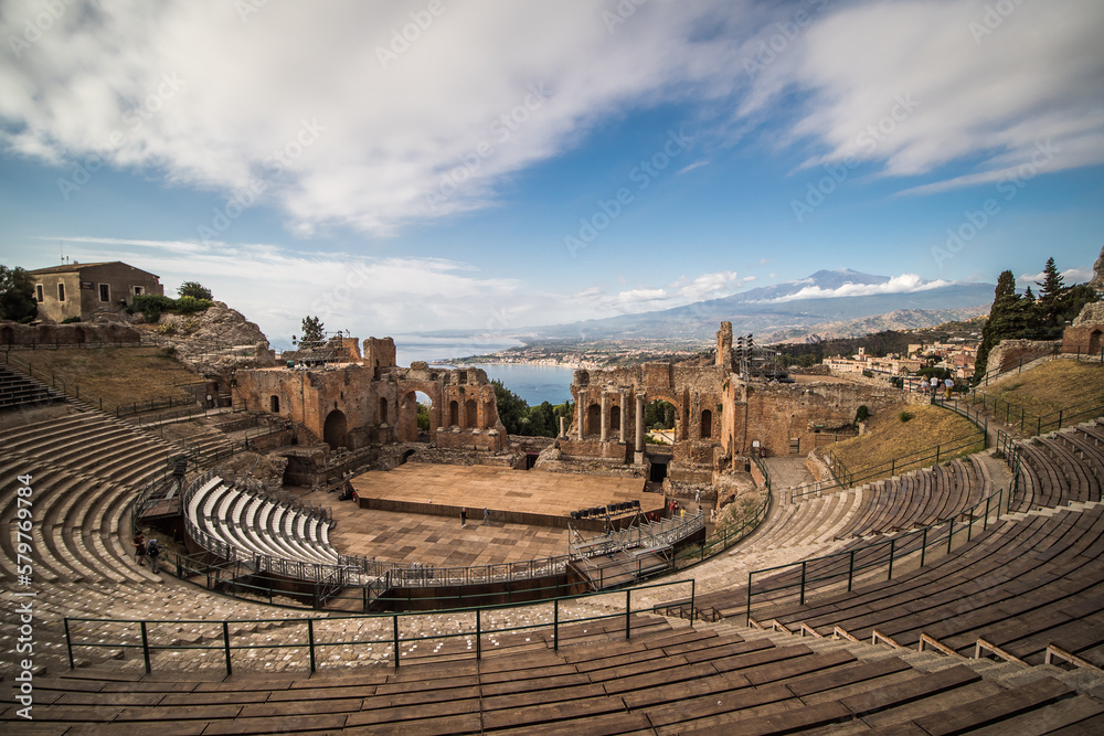 Ancient town Taormina in Sicily, Italy with antique theatre in Mediterranean With Etna Volcano