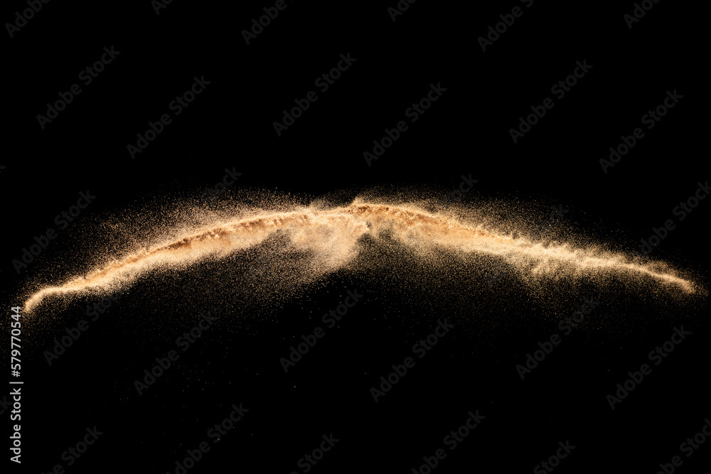 Sand explosion isolated on black background. Freeze motion of sandy dust splash. - obrazy, fototapety, plakaty 