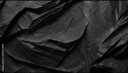 Abstract background of a sheet of black crumpled paper