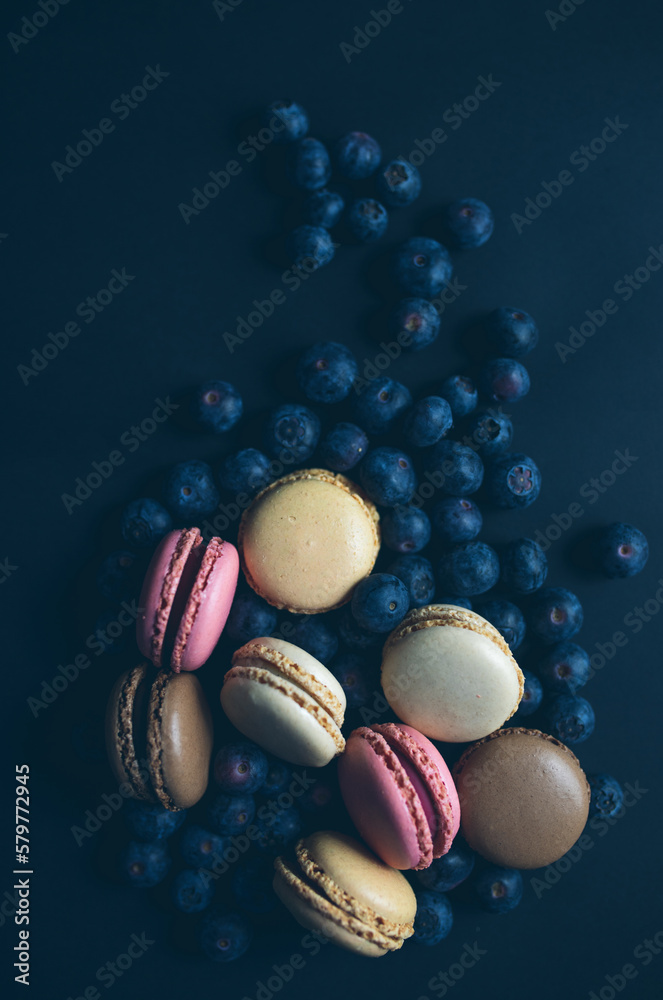 Macarons and blueberries on a black background Macarons and blueberries on a black background