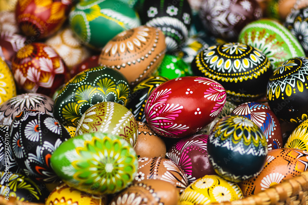 Traditional Lithuanian wooden colorful Easter eggs in a wicker basket, symbol of fertility and life painted with the symbols of nature