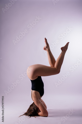 Athletic woman in swimsuit, doing yoga, push-ups, beautiful female exercising at studio © Ivan Zelenin