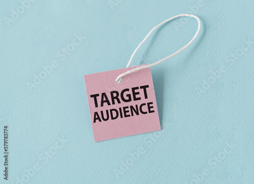 Target Audience text quote on a pink card, Business Concept on Blue Background.