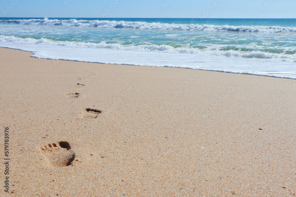 Print of foot steps on wet sand Print of foot steps on wet sand