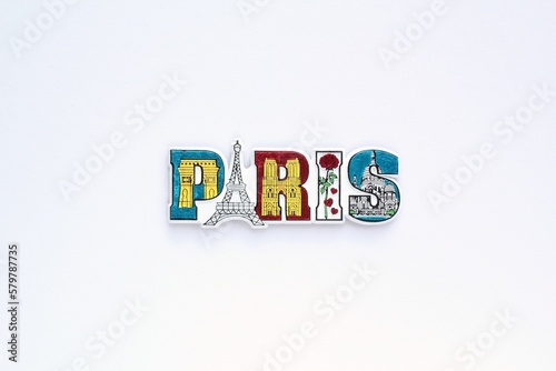 Colourful PVC souvenir fridge magnet of Paris, France on white background. Travel memory concept. Gift typical product for tourists from foreign trip. Home decoration. Top view, flat lay, close up