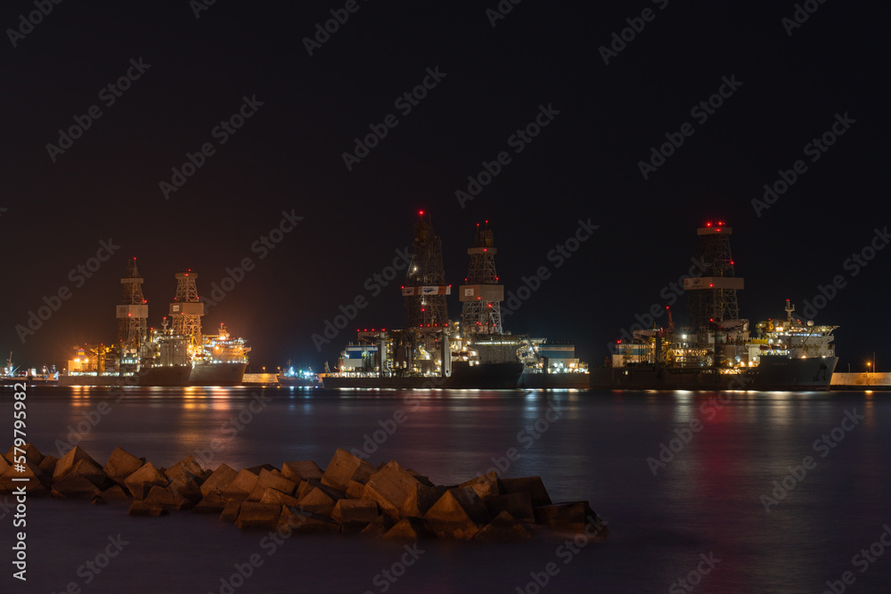 Night view of oil rigs docked at port in Las Palmas de Gran Canaria, Spain