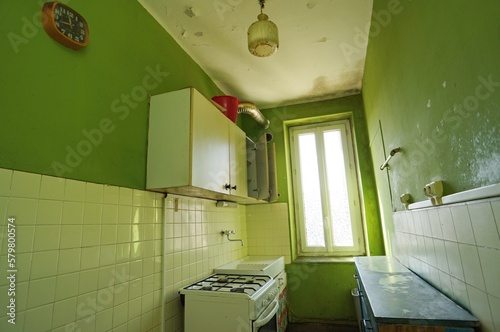 Slum landlord kitchen rental. Insalubrious kitchen. Abandoned kitchen. Careless tenant. Disgusting oily ceiling light.