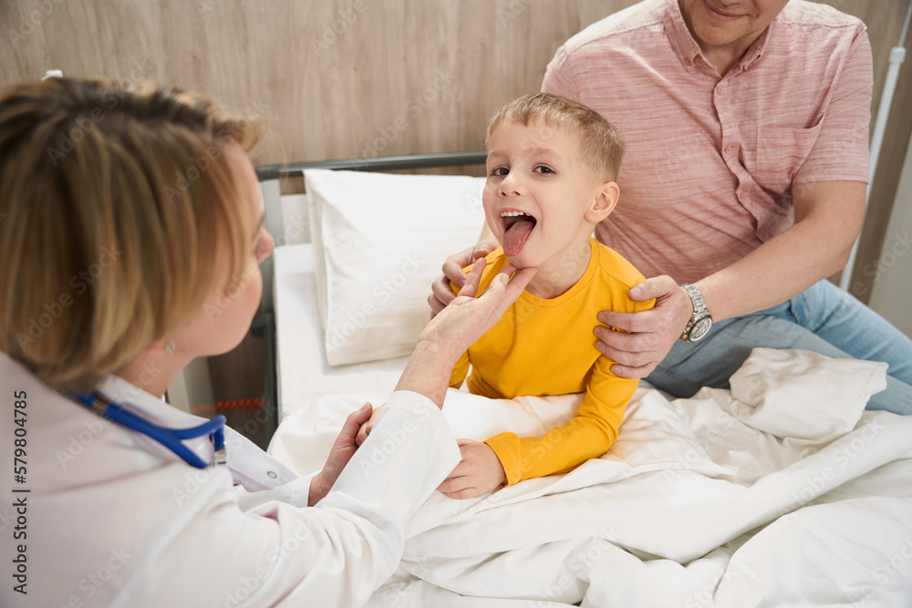 Blonde Caucasian child is getting consultation with doctor in children hospital Blonde Caucasian child is getting consultation with doctor in children hospital