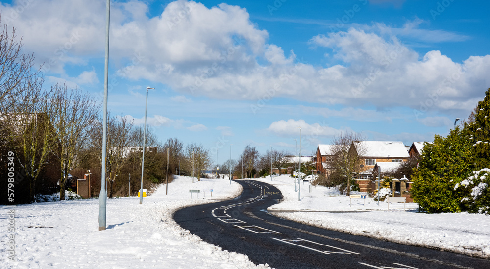 Winter landscape with snow covering the road in village, Snow on street road in small town with bright light morning.