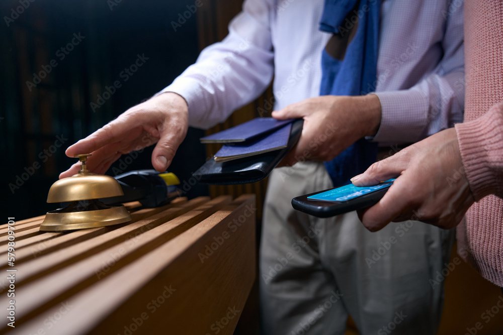 Man in travel clothes calls the hotel staff for registration Man in travel clothes calls the hotel staff for registration