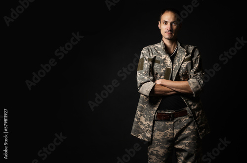 Serious Army Soldier on black background.
