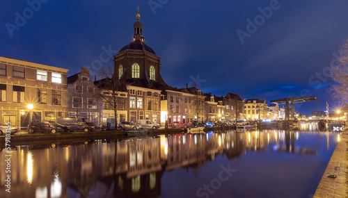 Beautiful old houses on the city embankment of Leiden at sunset.