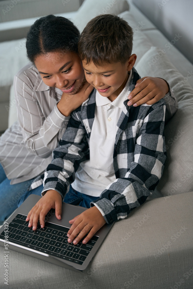 Boy is typing at home on laptop Boy is typing at home on laptop