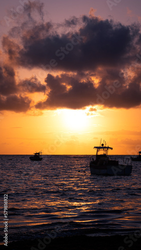 Sunrise on the beach with boats