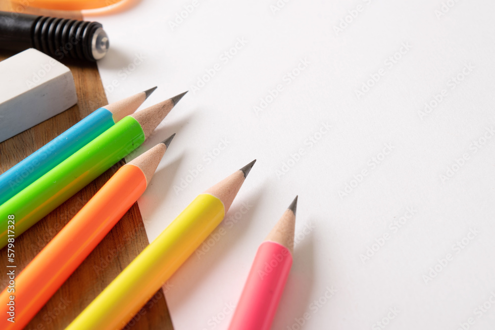 Bunch of sharp pencil and eraser on white paper still life image