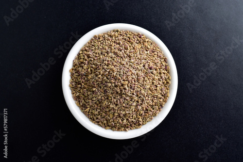 Top View of Ajwain Seeds in Bowl on Dark Background photo