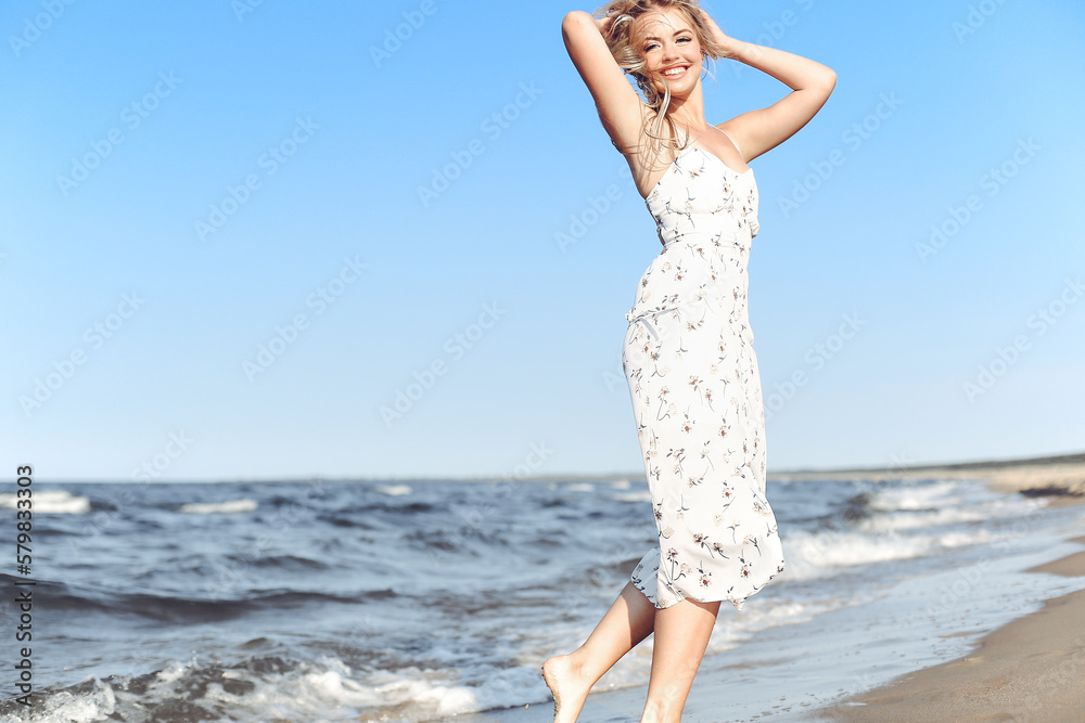 Happy blonde beautiful woman having fun on ocean beach while dancing in waves. Happy blonde beautiful woman having fun on ocean beach while dancing in waves.
