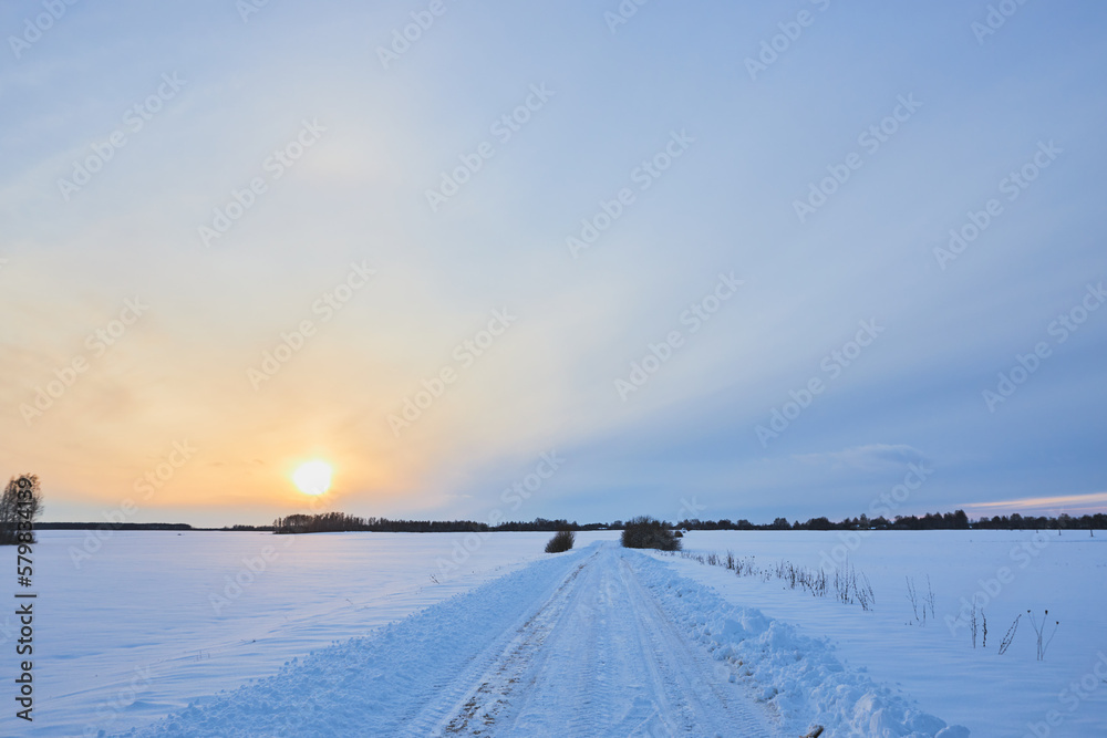 Sunset on a snowy road. Off-road on a snow-covered road. Sunset on a snowy road. Off-road on a snow-covered road.